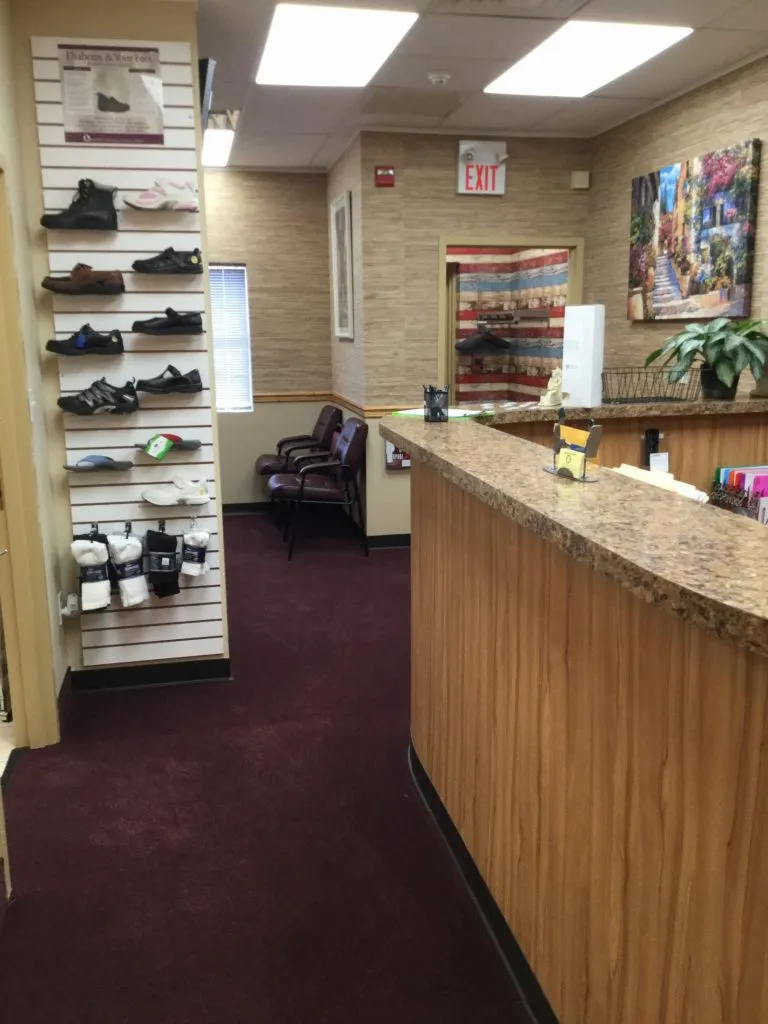 Interior photo: Front desk with waiting room and footwear and inserts on display, Ronkonkoma NY