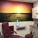 Ronkonkoma NY Podiatry Interior photo: Relaxing patient chair in treatment room with sunset over a field photo mural