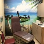 Ronkonkoma NY Podiatry Interior photo: Relaxing patient chair in treatment room with tropical beach photo mural