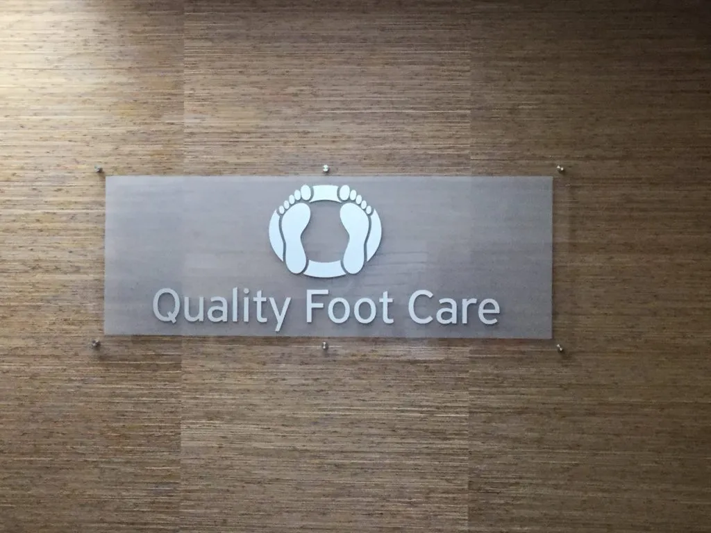 Ronkonkoma NY Podiatry Interior Photo: Office sign for Quality Foot Care with two feet on an oval