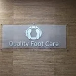 Ronkonkoma NY Podiatry Interior Photo: Office sign for Quality Foot Care with two feet on an oval
